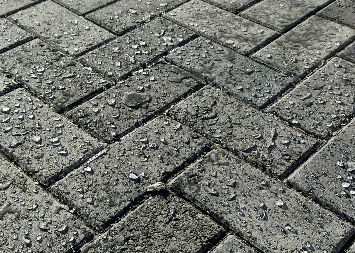 Close detail of finished pavers with water beading